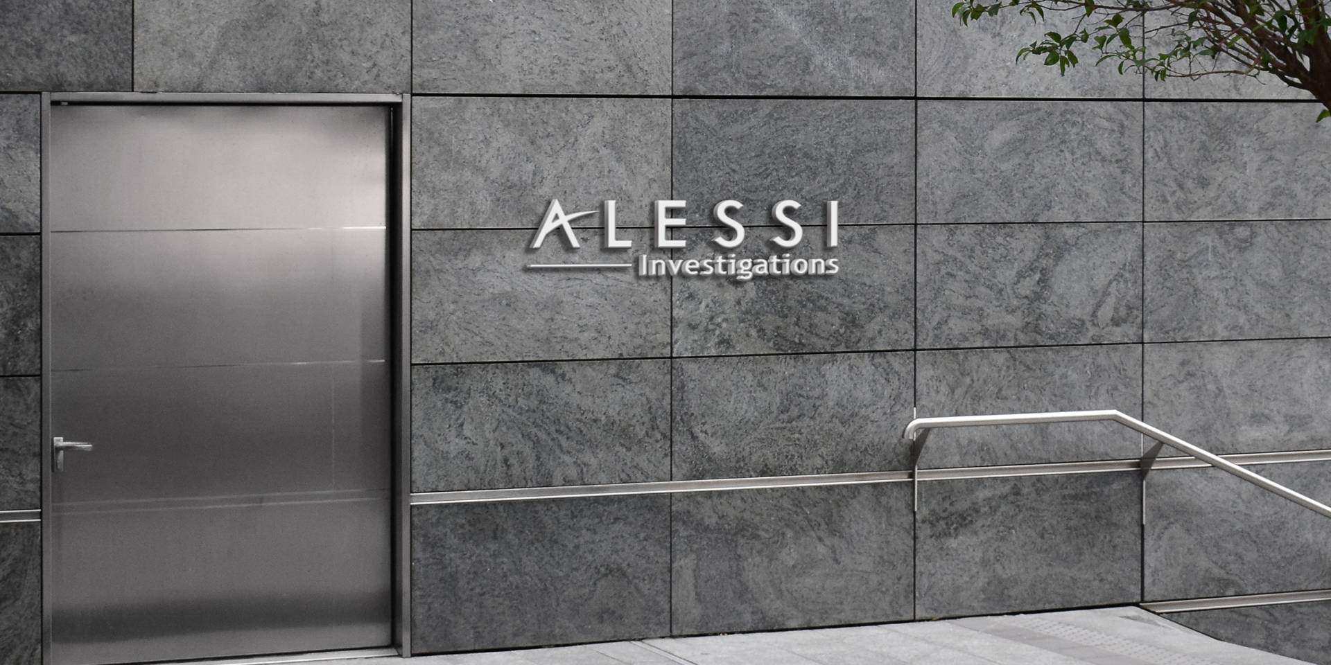 Alessi Investigations office sign on stone and steel in downtown Tulsa